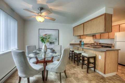 a kitchen and dining room with a table and chairs