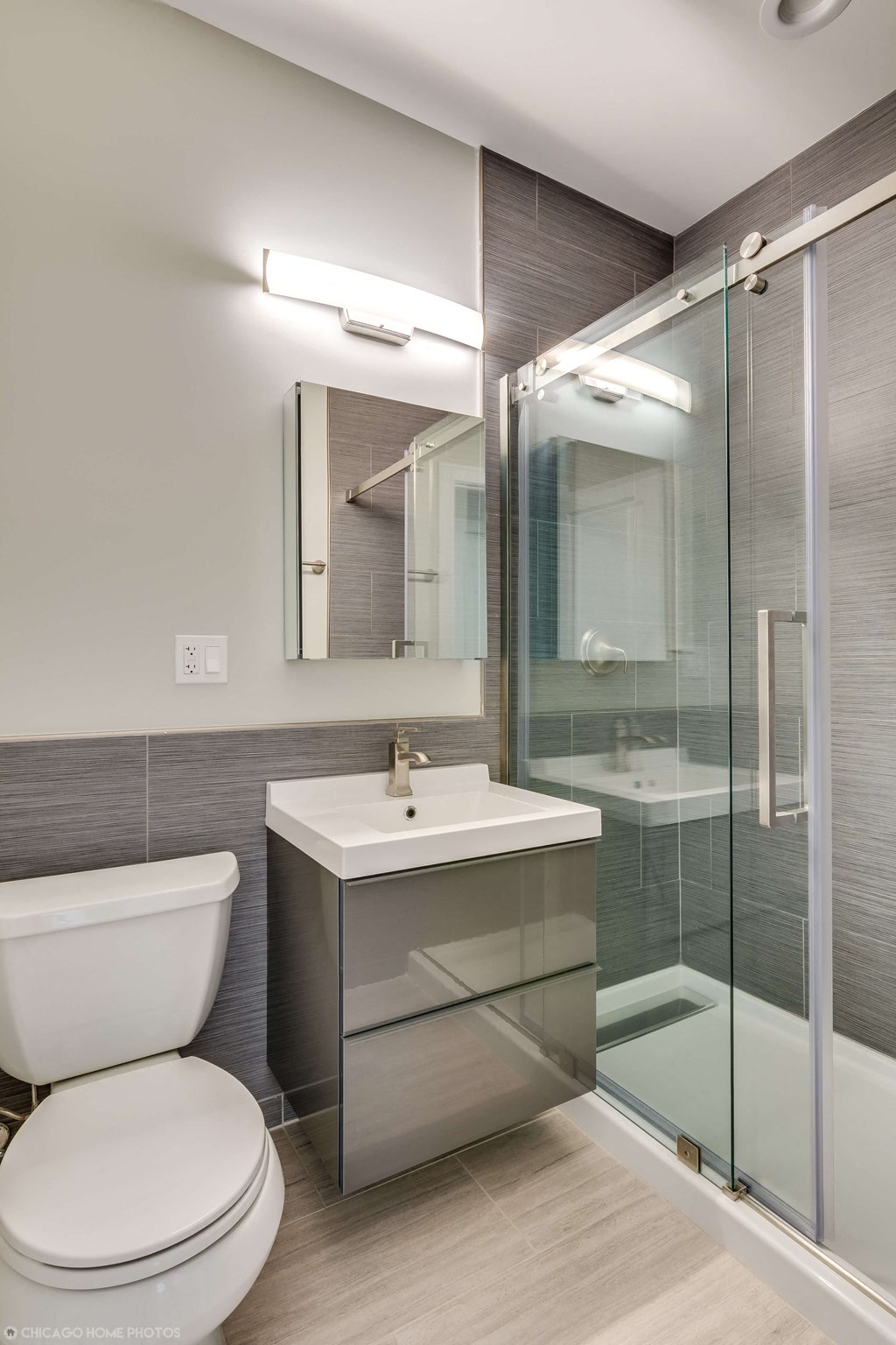 a bathroom with a toilet and a sink and a shower