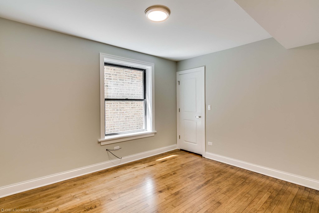 an empty living room with a window and a door
