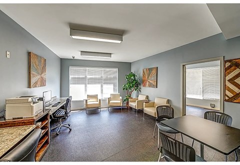 an office space with a desk and chairs and a printer