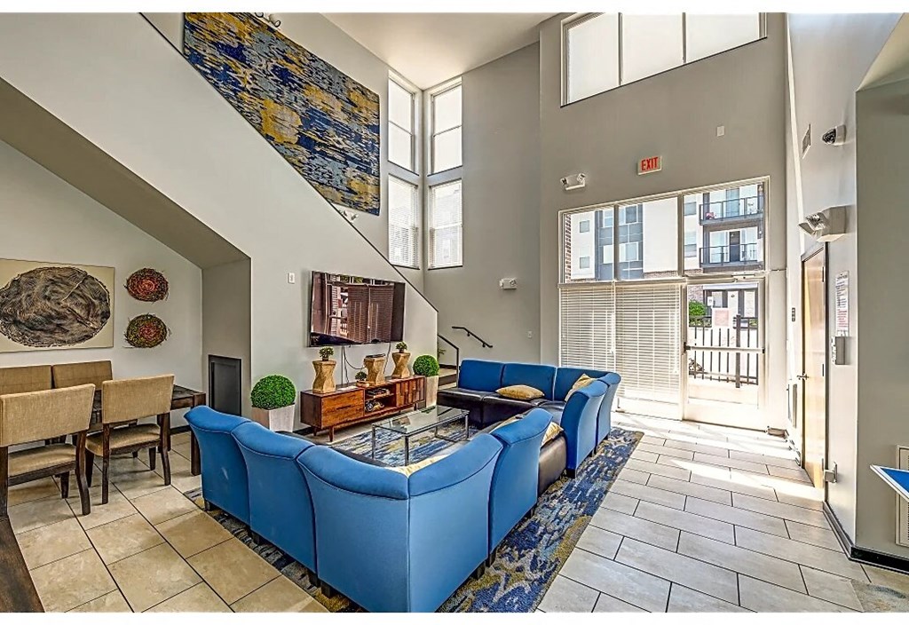 a living room with a blue couch and a glass table
