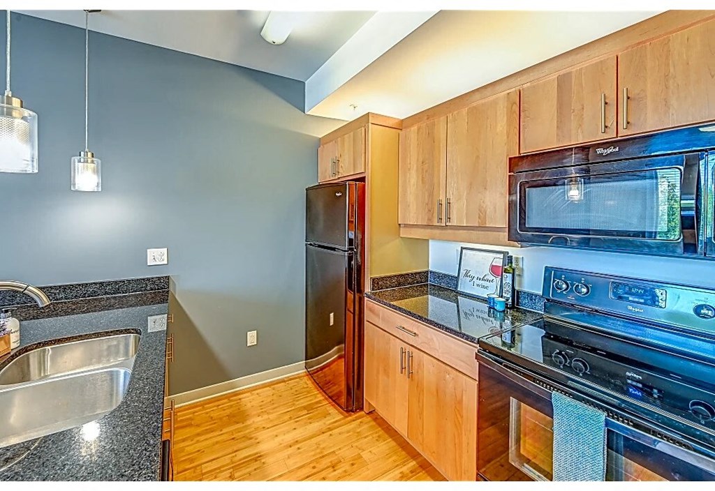 a kitchen with stainless steel appliances and wooden cabinets
