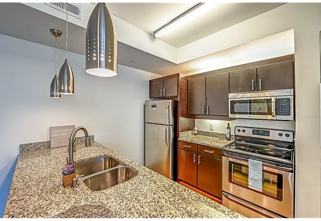 a kitchen with stainless steel appliances and granite counter tops