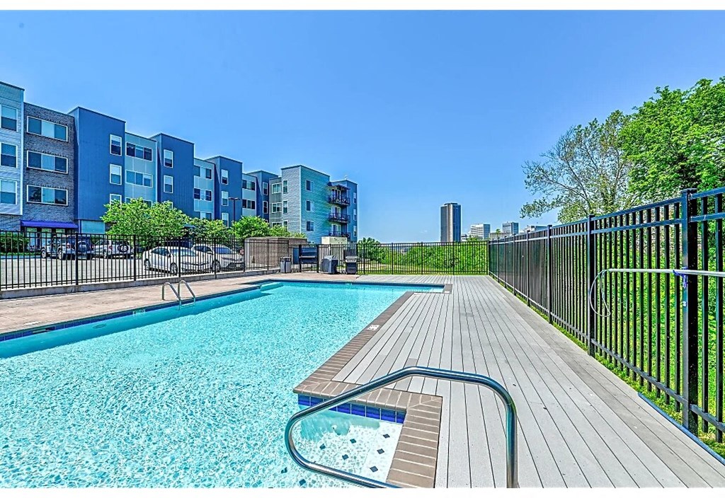 a swimming pool is next to a fence and a building