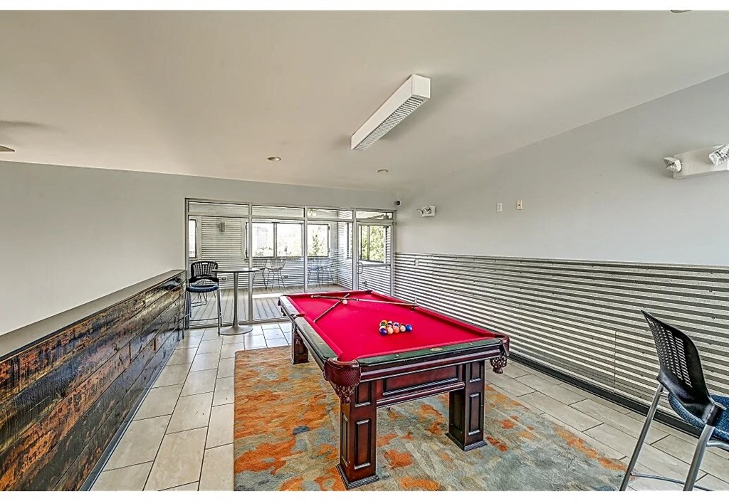 a game room with a red pool table