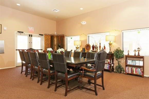 a dining room with a long table and chairs