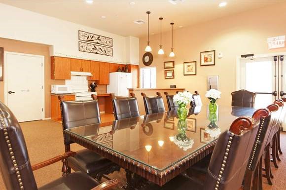 a large dining room with a table and chairs