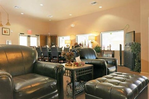 a living room and dining room with leather furniture