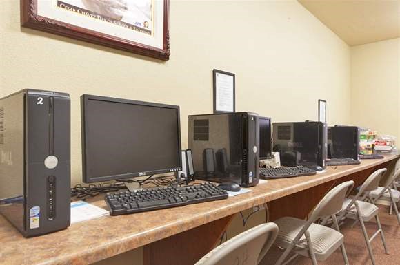 a long desk with several computers on it