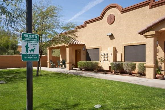 a sign on a pole in front of a house