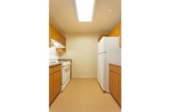 a kitchen with white appliances and wooden cabinets