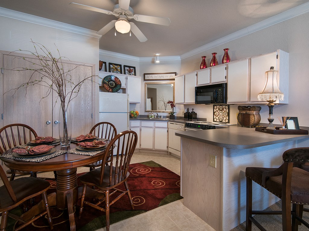 a kitchen and dining room with a table and chairs