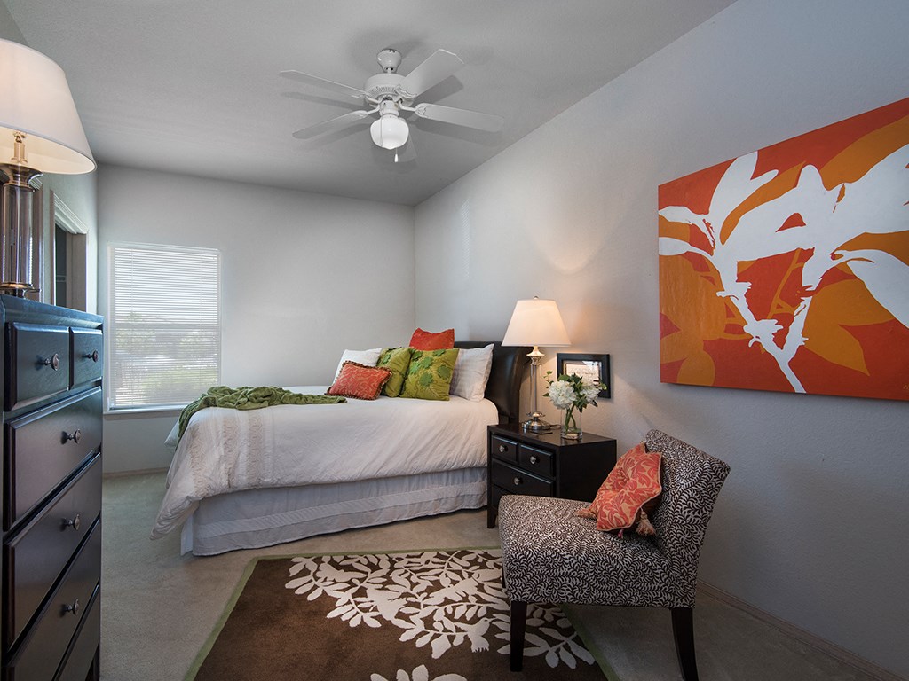 a bedroom with a bed and a ceiling fan