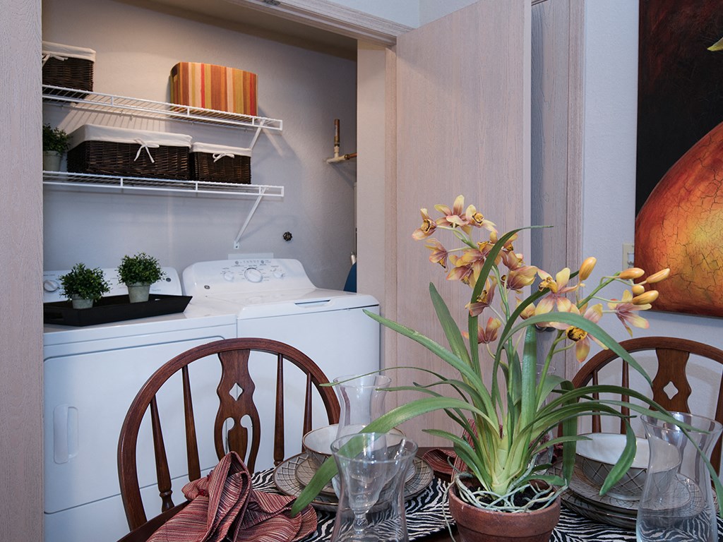 a dining room with a table with flowers and a sewing machine
