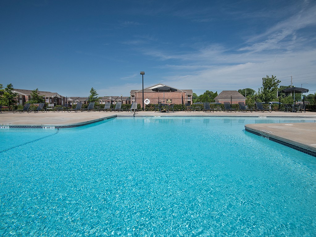 a large pool with a building in the background