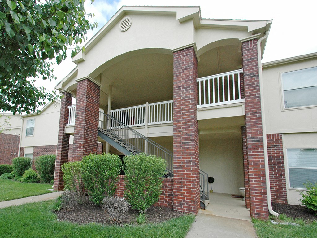 an exterior view of a building with a porch and stairs
