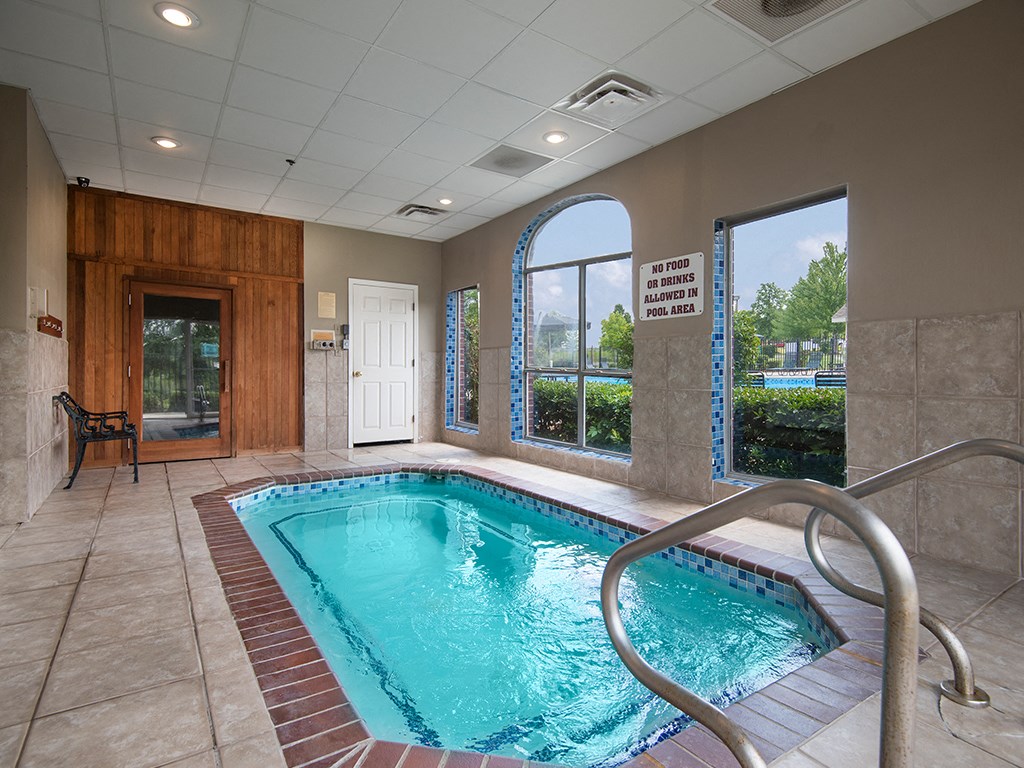 a swimming pool in a building with a door and a window