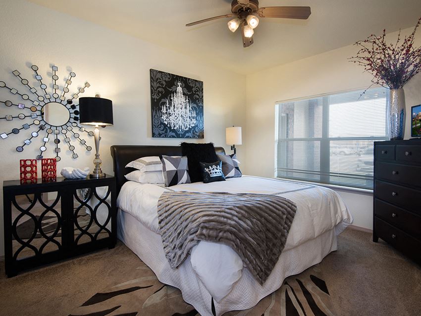 a bedroom with a large bed and a ceiling fan