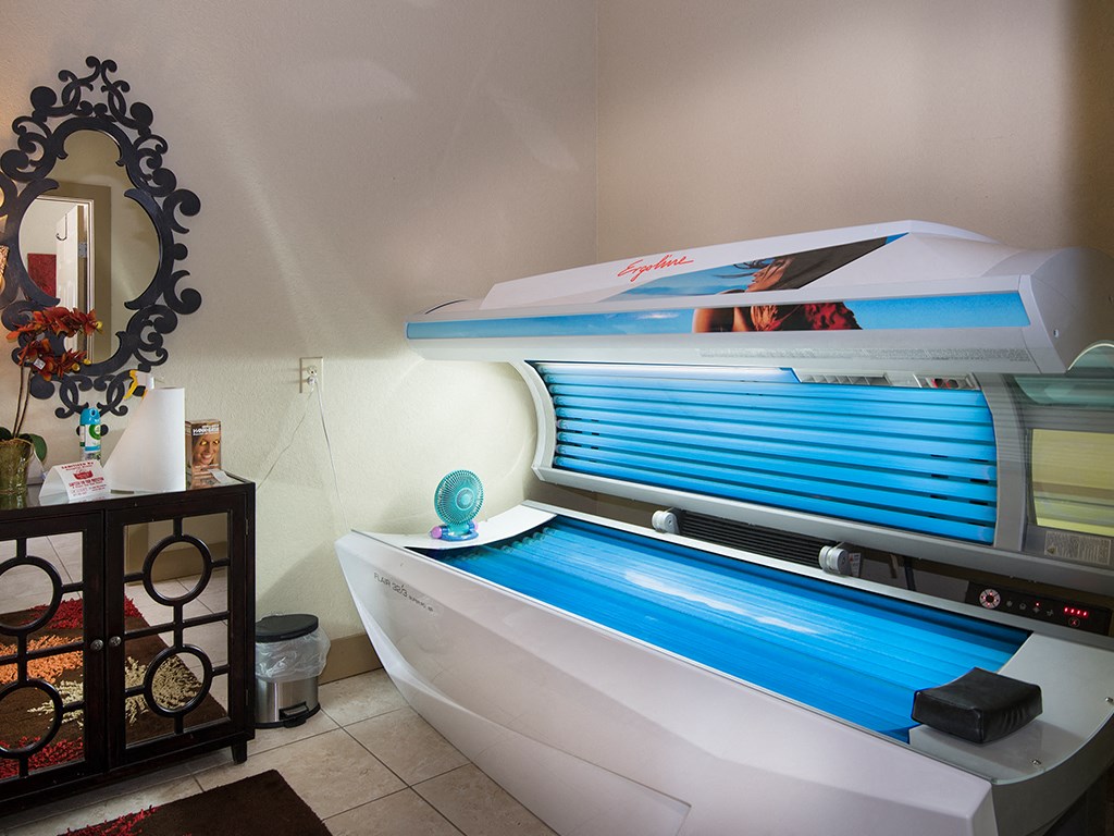 a spa tub in a bathroom with a vanity and a mirror