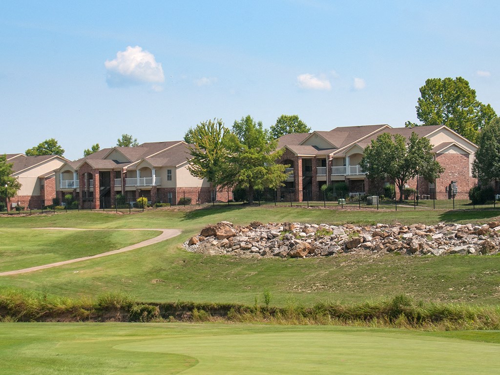 a golf course with houses in the background