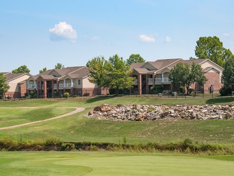 a golf course with houses in the background