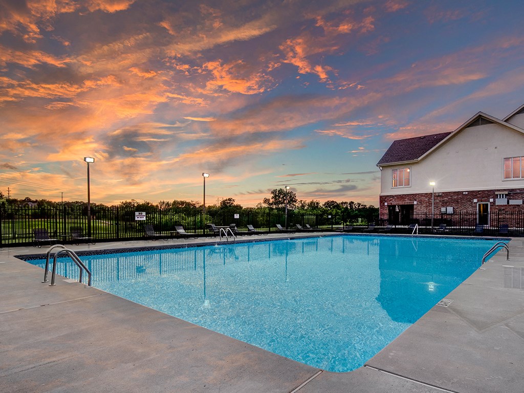 the swimming pool at our apartments with a sunset in the background
