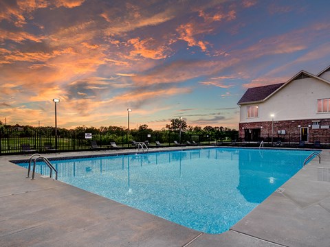 the swimming pool at our apartments with a sunset in the background