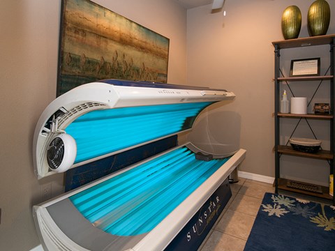 a spa room with a pool and a massage bed in it