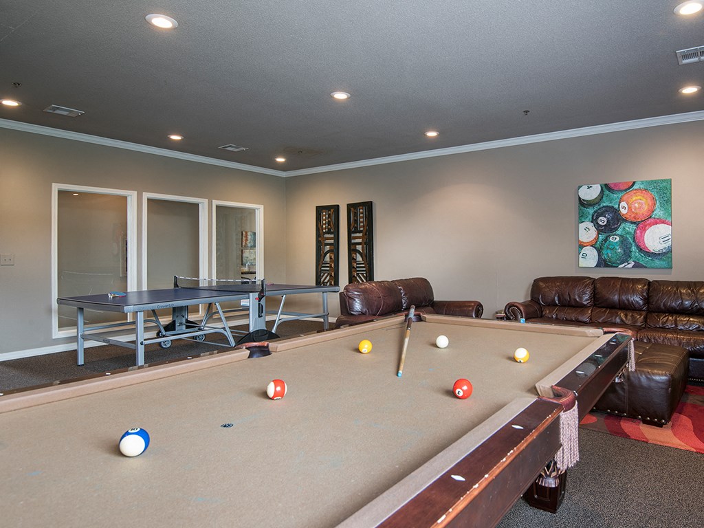 a game room with a pool table and a ping pong table