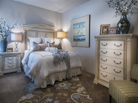 a bedroom with a bed and a dresser