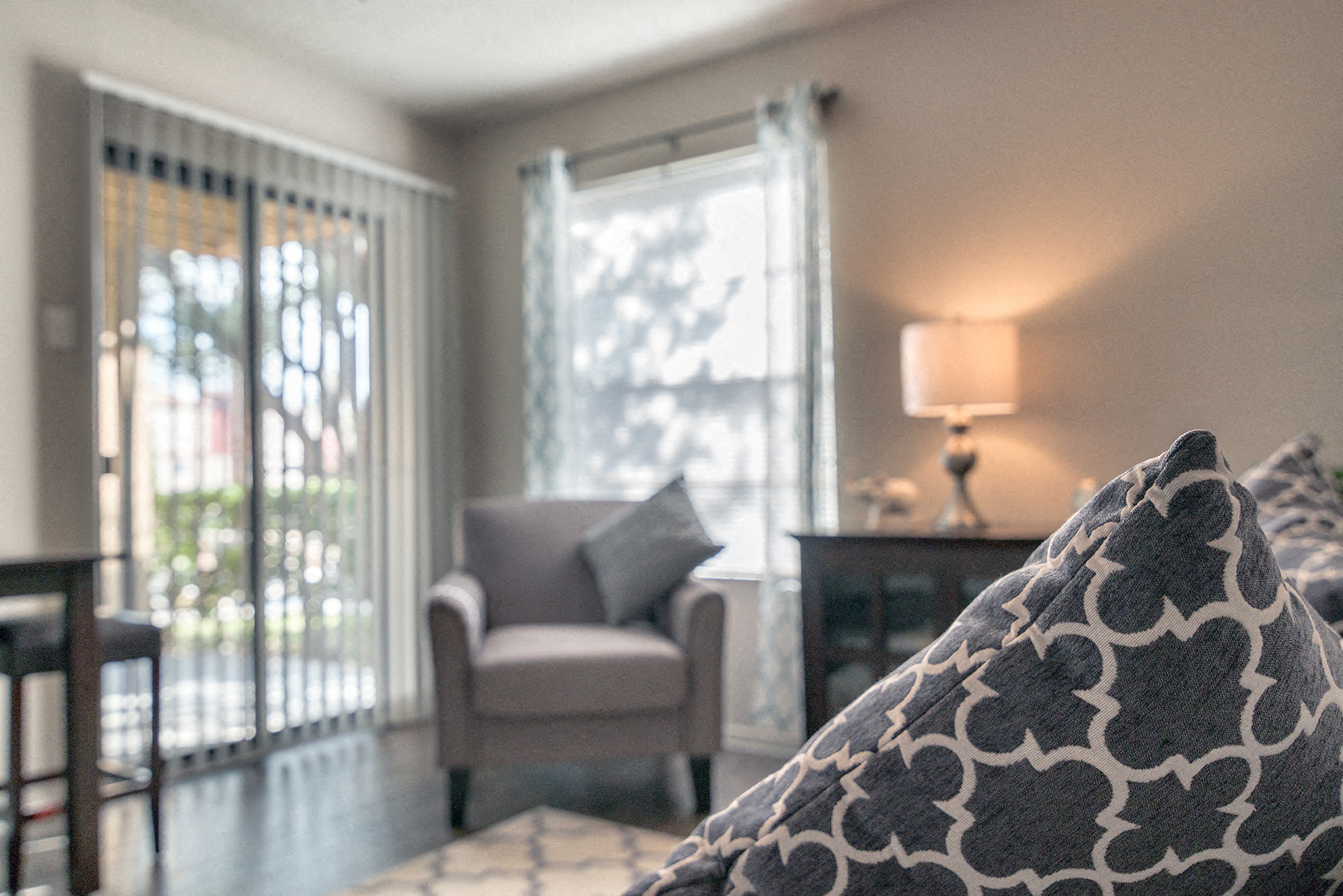 a bedroom with a bed and a chair and a window
