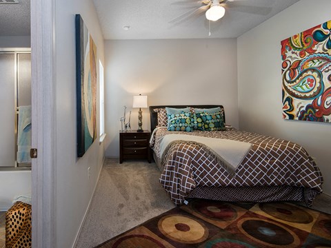 a bedroom with a bed and a ceiling fan