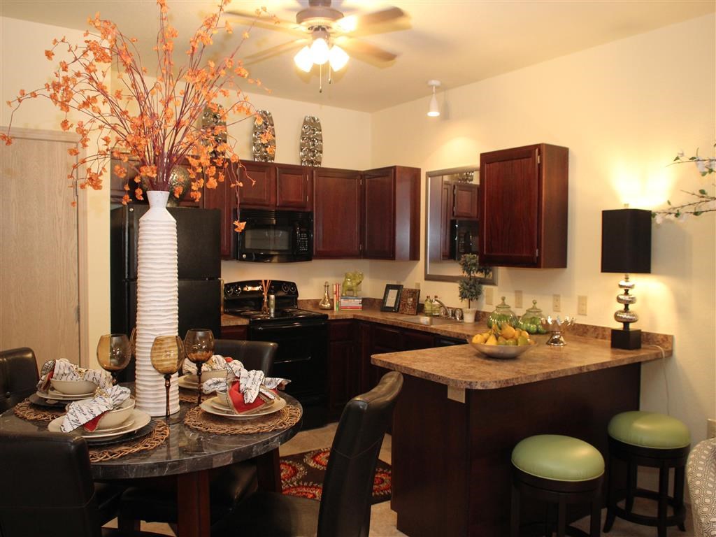 a kitchen and dining room with a table and chairs