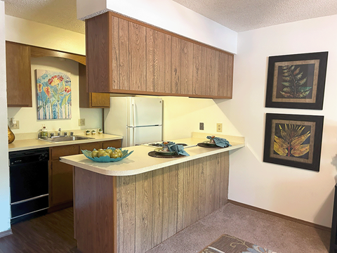 a kitchen with a counter top and a refrigerator