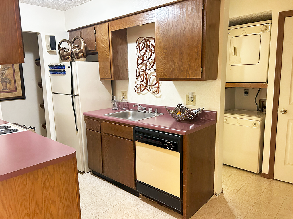 a kitchen with a sink and a refrigerator