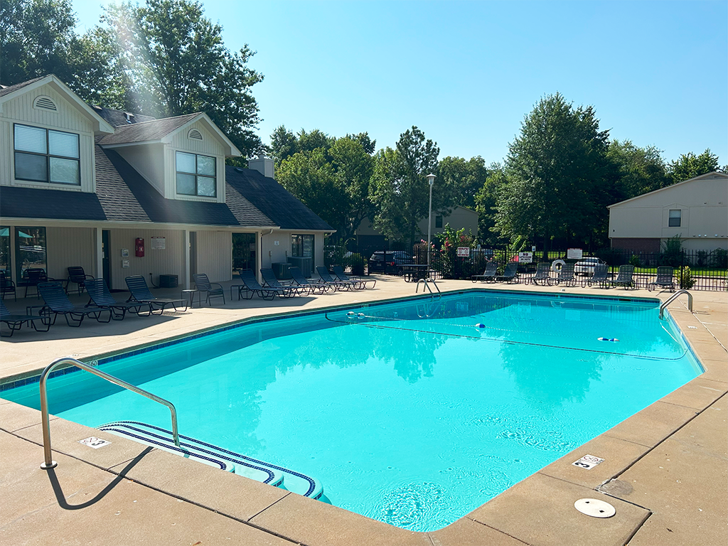 a swimming pool with a house in the background