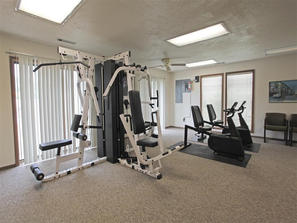 the fitness room has plenty of exercise equipment in it