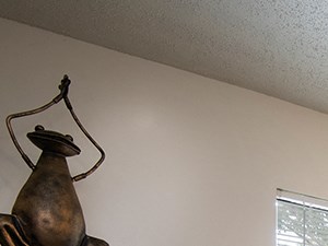 a bedroom with a bed and a dresser and a ceiling fan