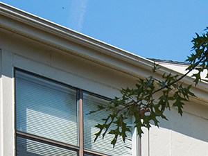 an apartment building with brick pillars and a balcony