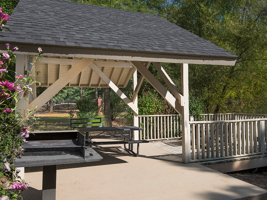 a pavilion with a picnic table on a patio