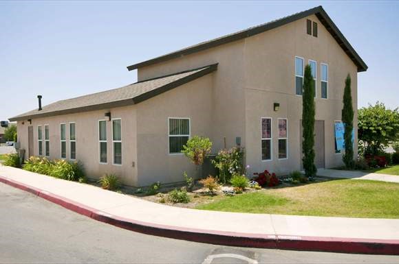 a beige house with a yard and a street