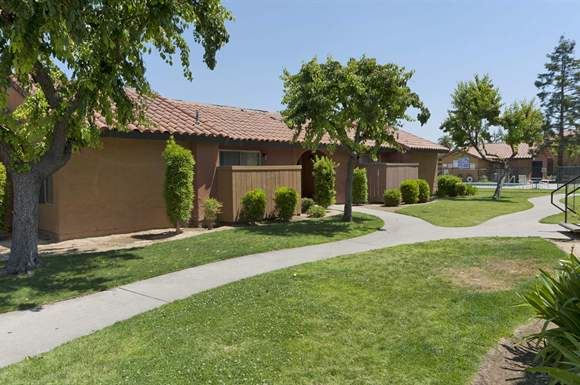 a house with a sidewalk in front of it