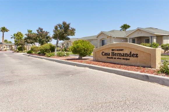 a sign for a car dealership on the side of a road