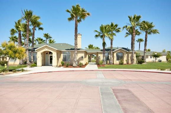 a house with a driveway and palm trees