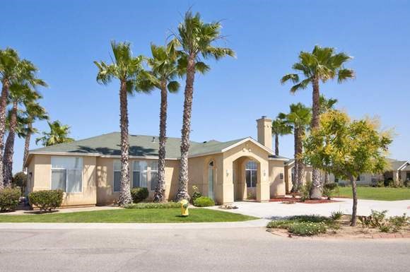 a house with palm trees in front of it