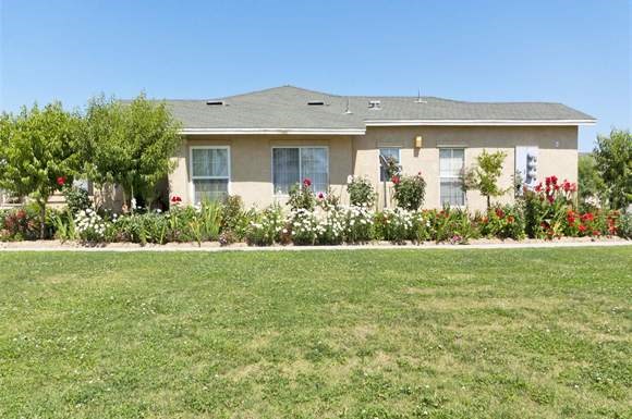 a house with a flower garden in front of it