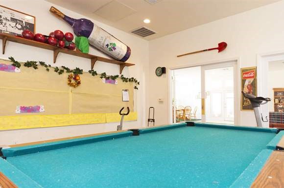 a pool table in a room with a door