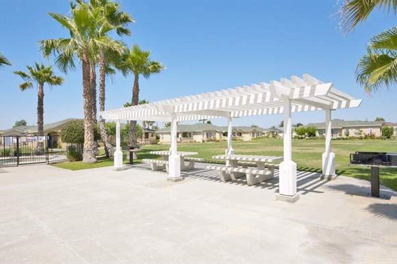 a group of white benches under a white canopy