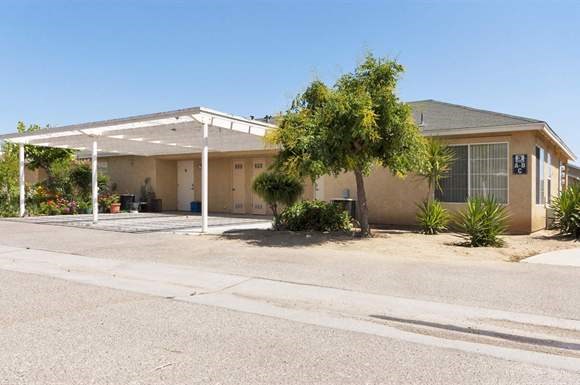 a house with a covered porch in a parking lot