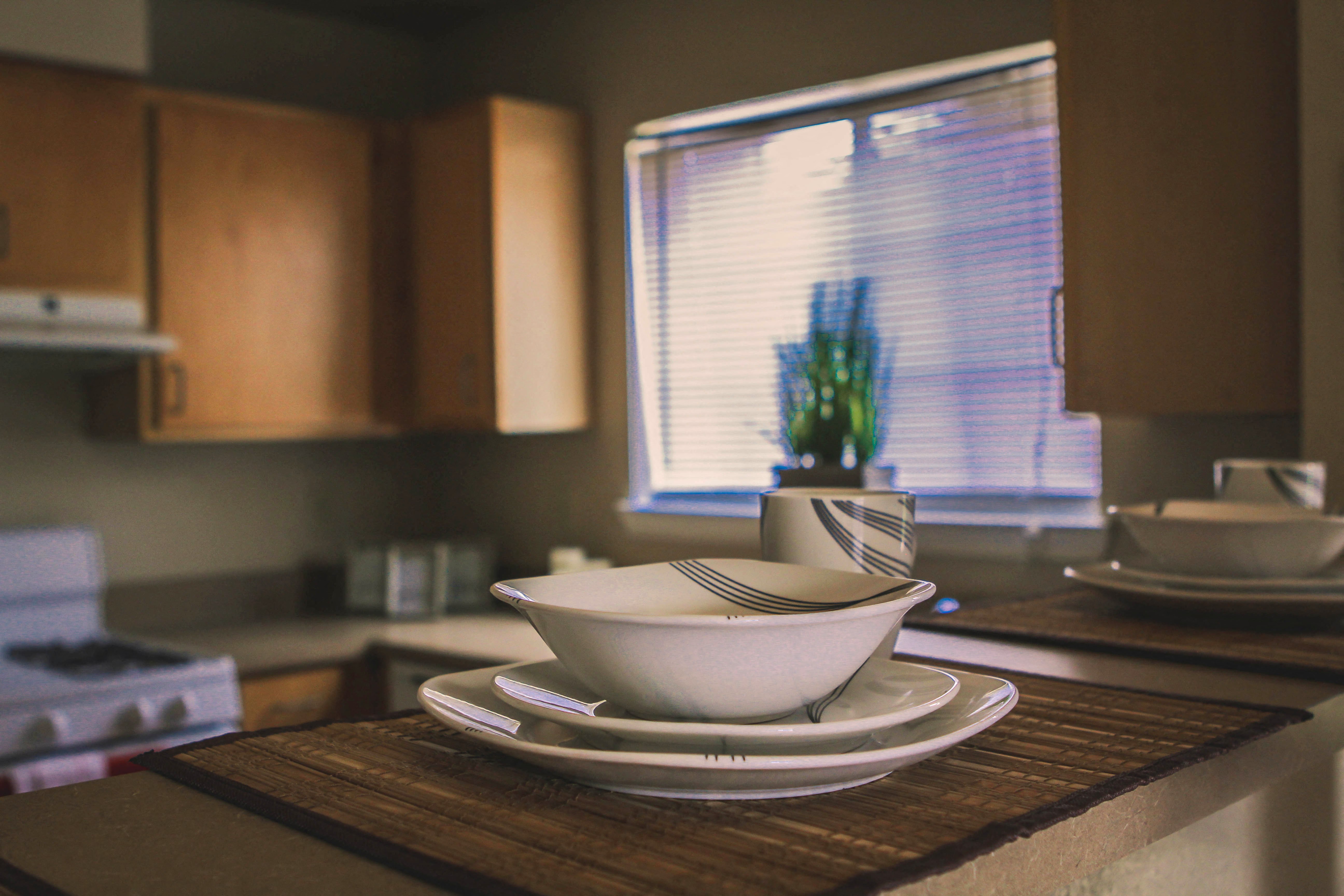 a kitchen counter with a bowl and plates on it